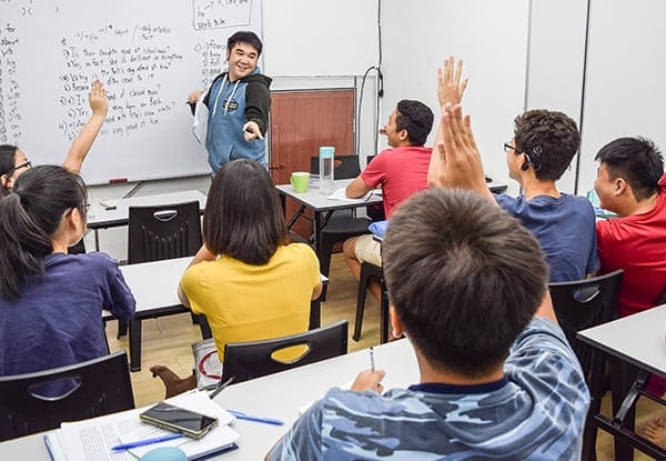 a teacher asking his students questions